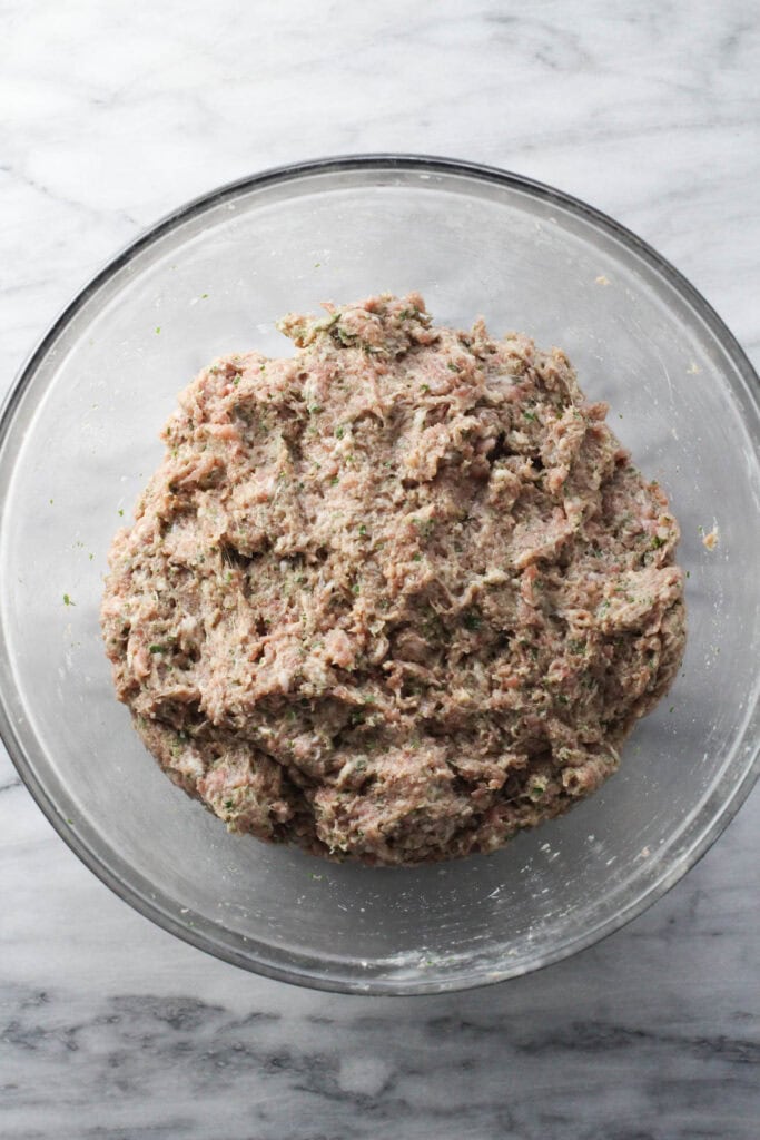 Raw meat mixture for Russian meat cutlets in a mixing bowl.