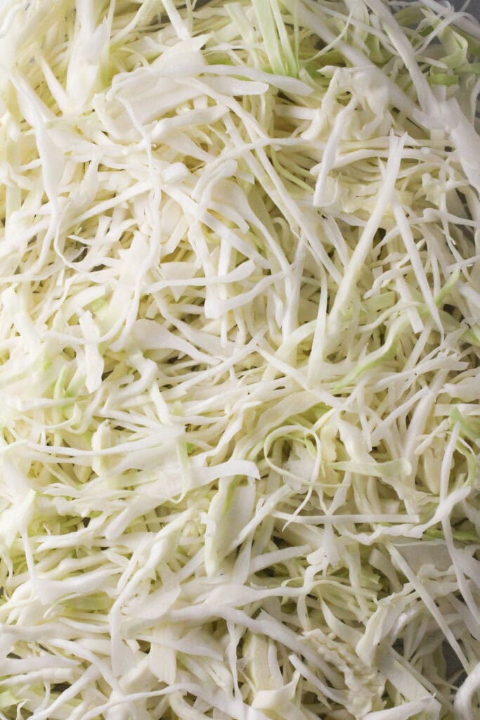 Shredded green cabbage ready for Krautsalat.