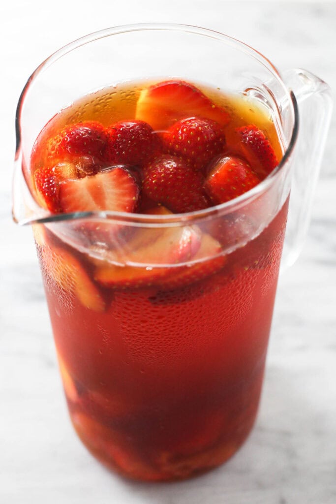 Fresh strawberry slices added to iced rooibos tea.