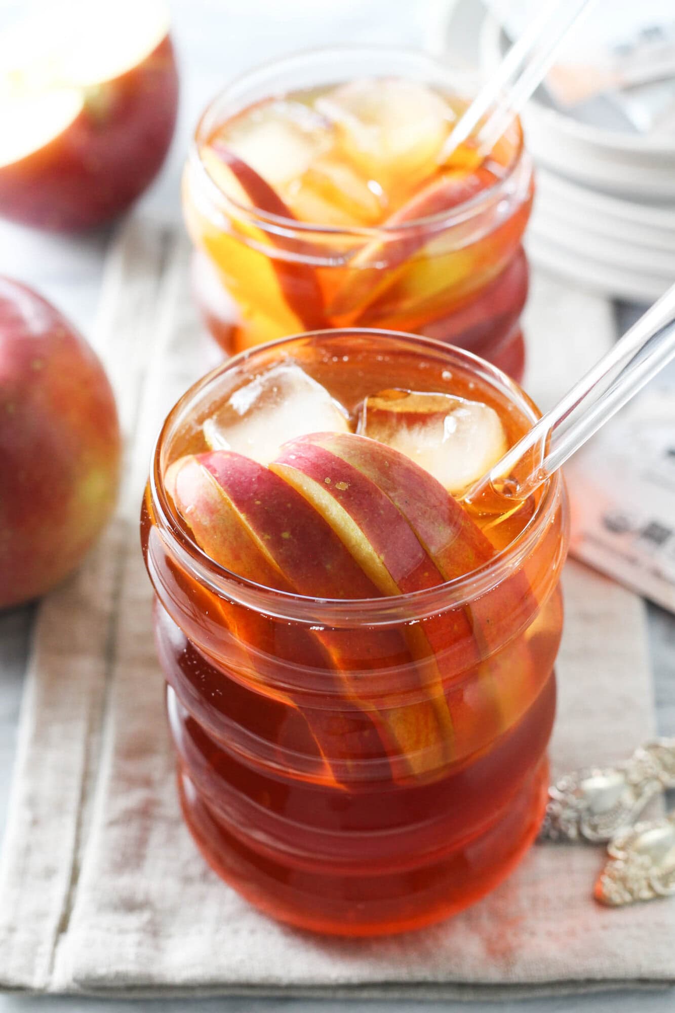 Apple rooibos iced tea served over ice with apple slices.